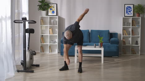 middle-aged-man-is-training-home-at-morning-tilts-and-stretching-exercises-gymnastics-for-joints-health-lifestyle-in-middle-age